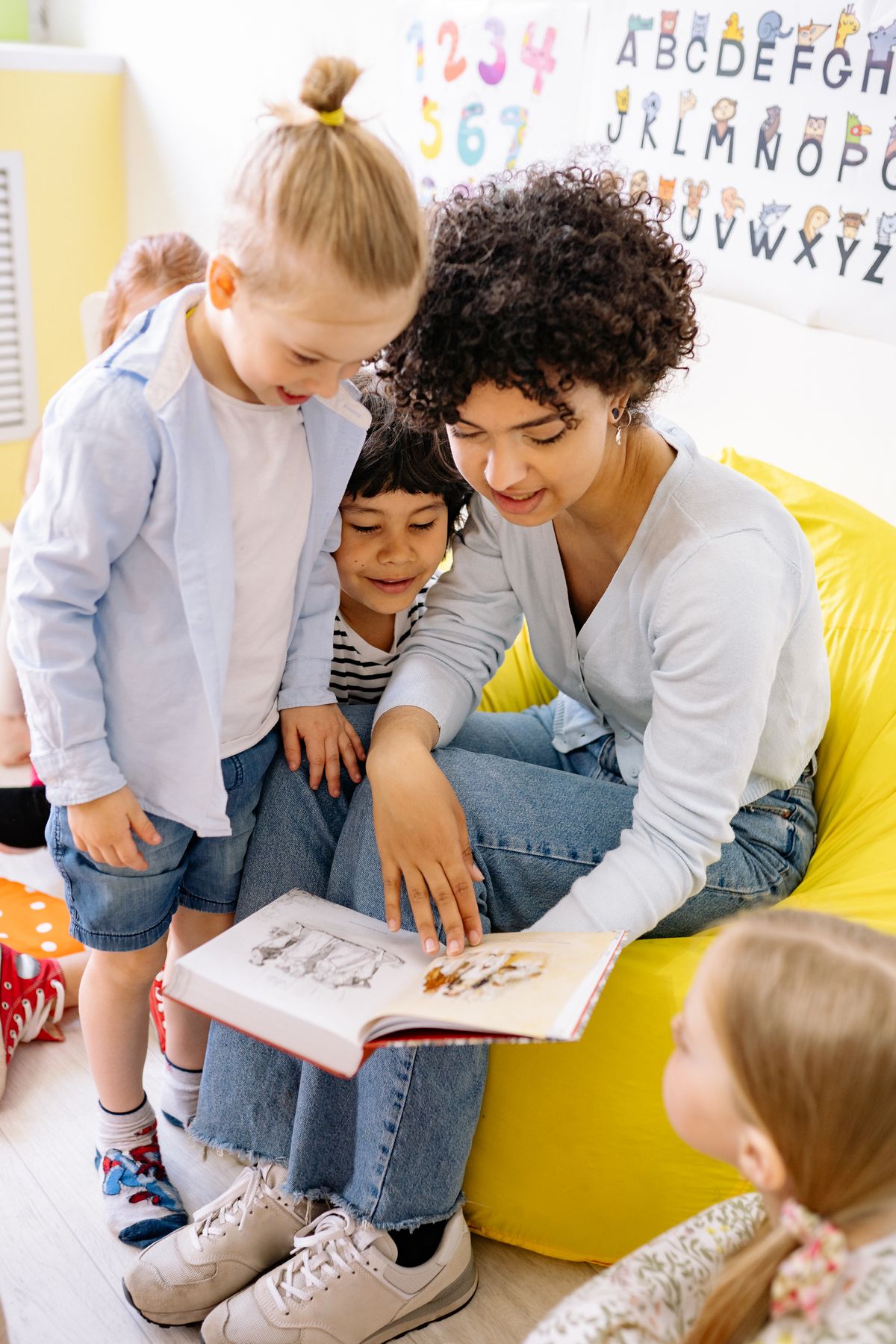 Montessori teacher reading with a young child